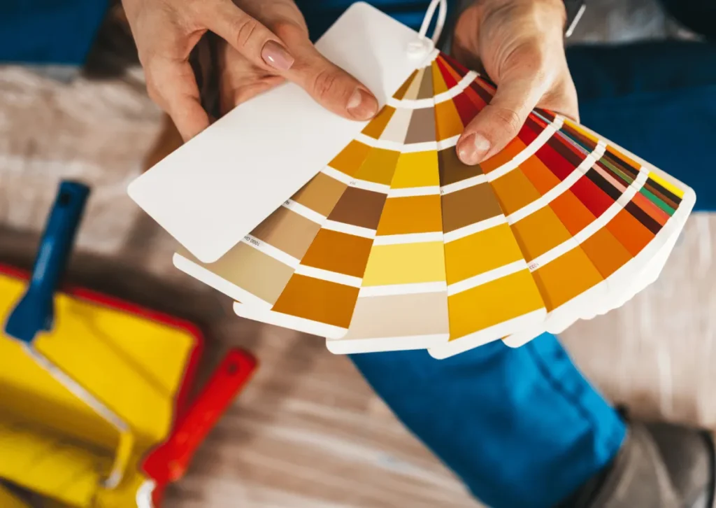Hand holding a paint colour fan deck